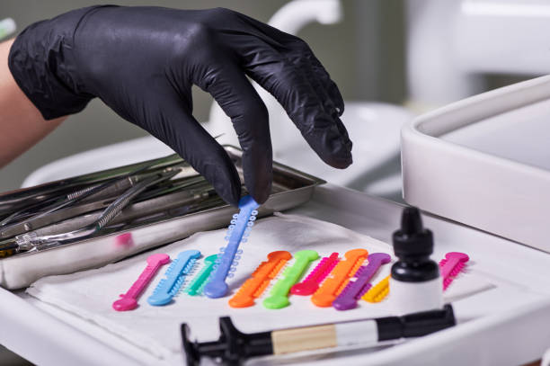 istock Orthodontist choosing orthodontic ligature for bracket placement. 1281462839