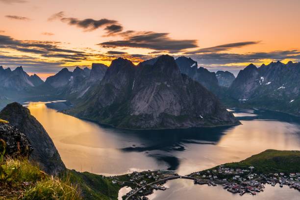 Reinebringen Beautiful view over Reine from the infamous Reinebringen peak, at midnight sun around 2 AM midnight sun stock pictures, royalty-free photos & images