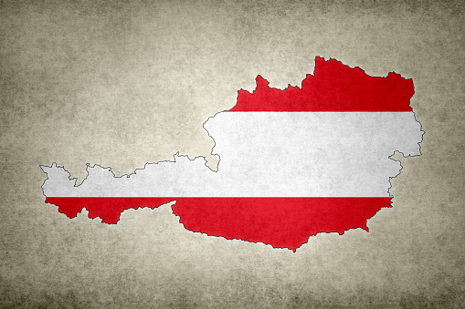 Grunge map of Austria with its flag printed within its border on an old paper.