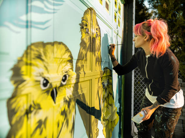 istock Female mural artist at work 1281465925