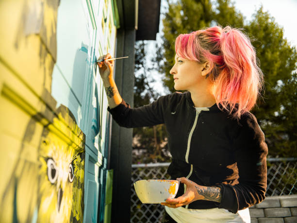 istock Female mural artist at work 1281466058