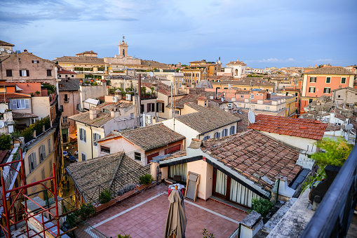 Rome, Italy -- A sunset light view from the rooftops of the iconic roman Pantheon and Piazza della Rotonda quarter, in the heart of Rome. At center the bell tower of the Italian Parliament in Piazza di Montecitorio. Image un High Definition Format.