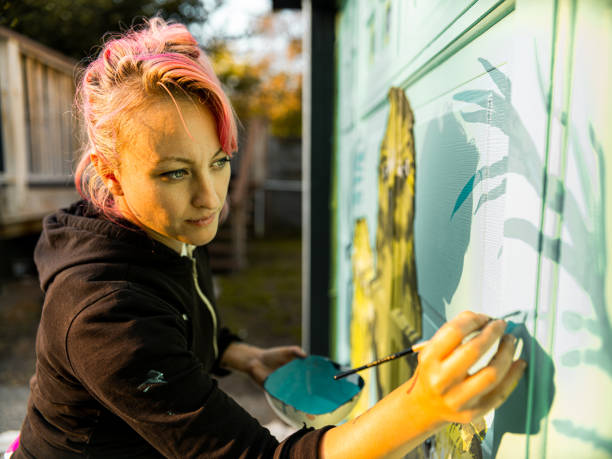 istock Female mural artist at work 1281466148