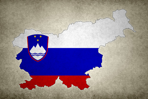 Grunge map of Slovenia with its flag printed within its border on an old paper.
