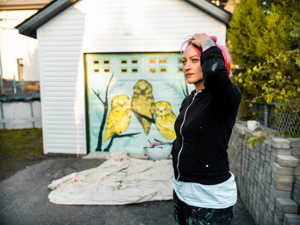 istock Female mural artist at work 1281467329