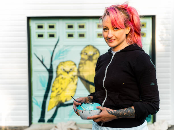 istock Female mural artist at work 1281467364