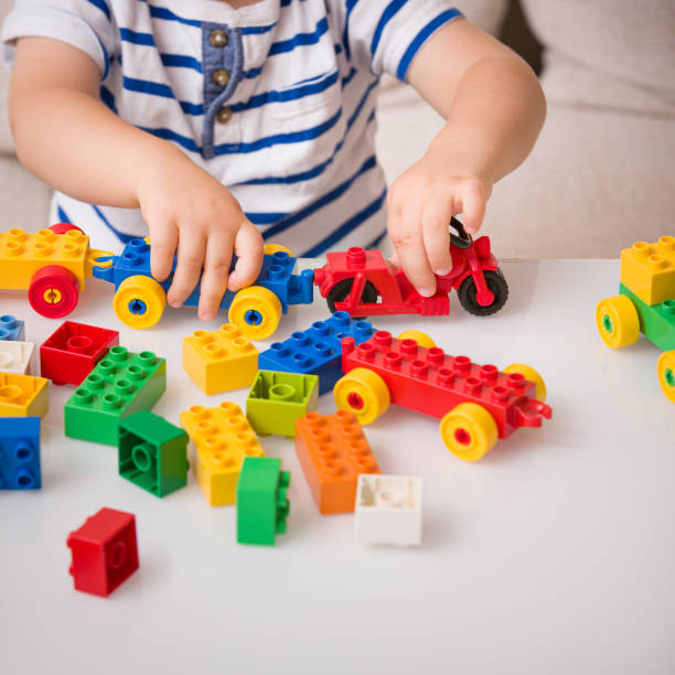 istock The boy plays colorful multi-colored cubes on the table. Early development and learning. Bright constructor for the game of plastic bricks. 1281467561