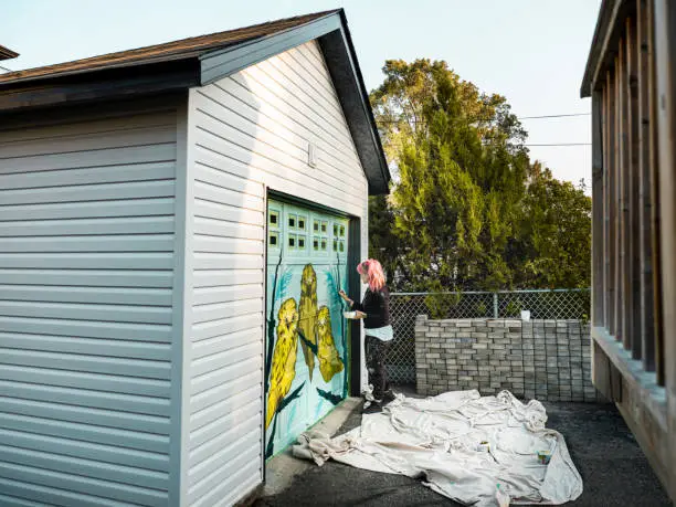 Photo of Female mural artist at work