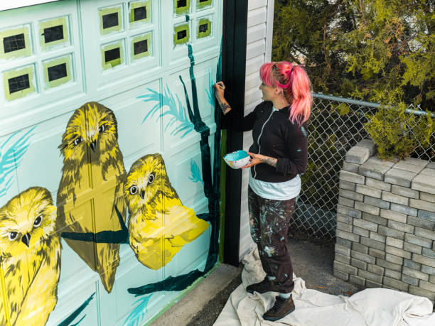 istock Female mural artist at work 1281467626