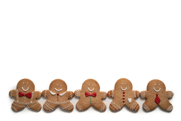 Christmas gingerbread men cookies five in a row isolated on white background with shadow