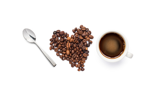 composition with coffee beans, spoon and black coffee cup