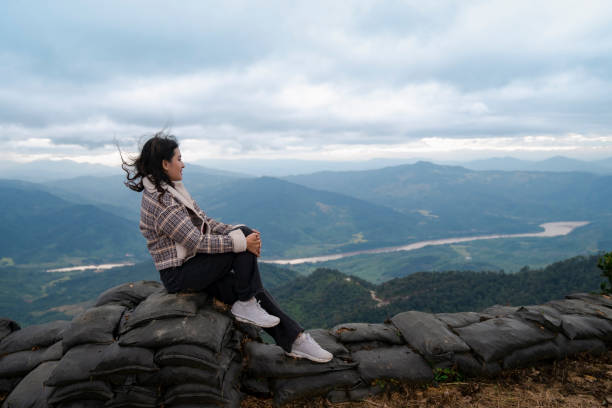 istock woman watch mountain and river view 1281472001