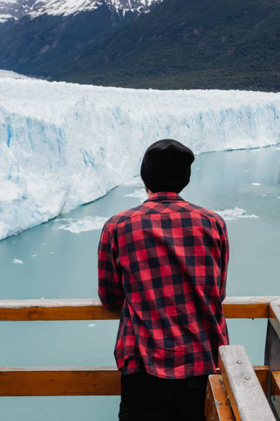 istock A young man is looking at Perito Moreno Glacier view from behind 1281472168