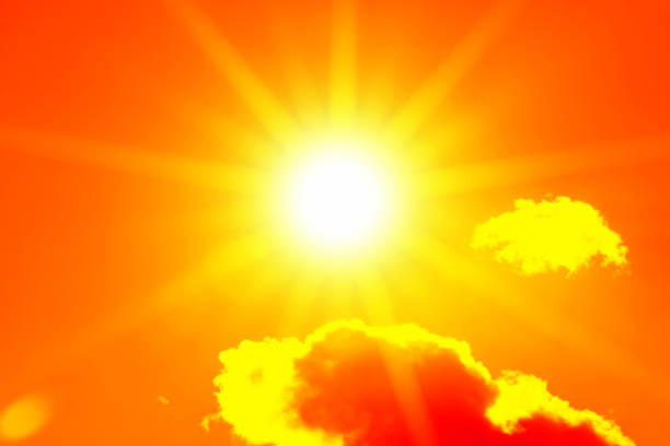 istock Bright sun with beautiful beams in the sky with clouds (toned in red) 1281472564