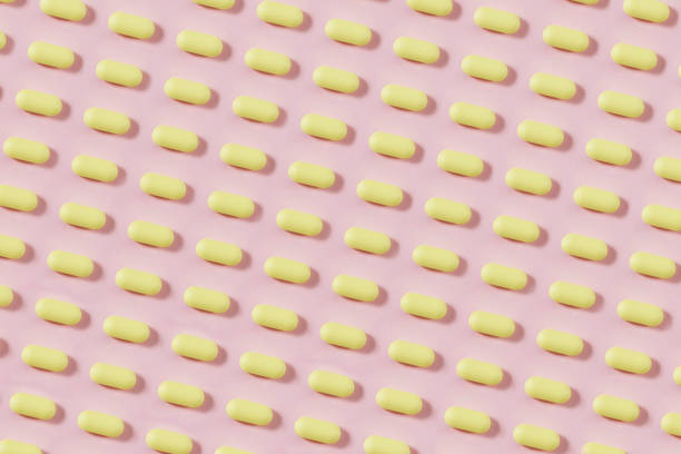 istock Yellow Pills on Pink Background 1281474185