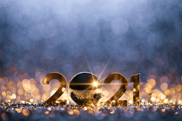 New Year Christmas Decoration 2021 - Gold Blue Party Celebration Golden numbers 2021 and Christmas decorations on glitter and defocused lights. 2021 stock pictures, royalty-free photos & images