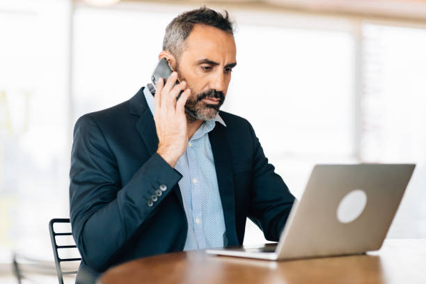 istock Businessman working on laptop in coworking space 1281474377