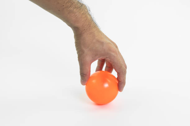 istock hand man holding color ball isolated on white background 1281474459