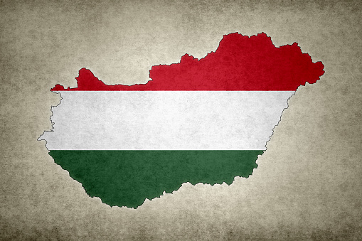 Grunge map of Hungary with its flag printed within its border on an old paper.