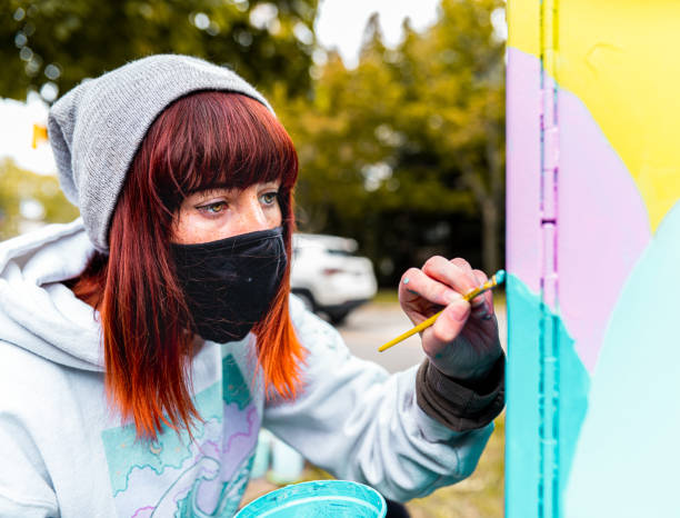 istock Female mural artist at work 1281478337