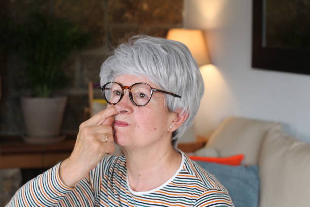 istock Senior woman picking her nose at home 1281479765