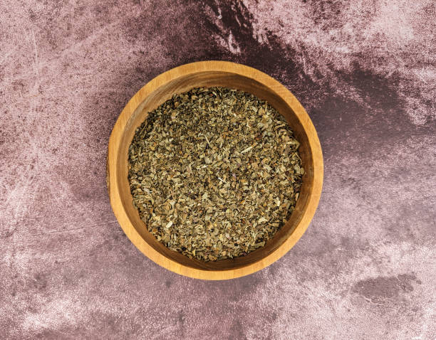 istock Chopped basil leaves on a mottled maroon background 1281479857