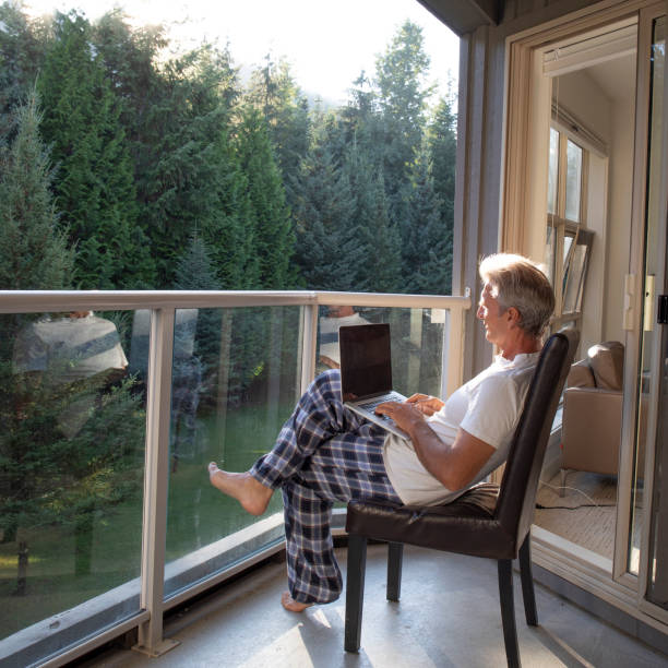istock Man relaxes on sunlit deck in morning 1281481268