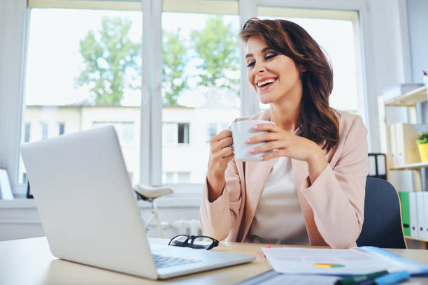 istock Happy woman working from home, drinking coffee 1281481458