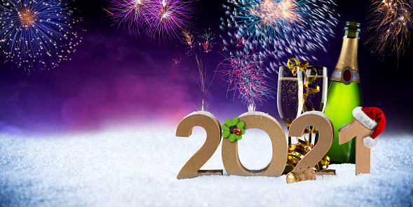 happy new year eve 2021 number colorful fireworks with santa hat four leaf clover champagne bottle glass on snow front of red purple blue black bokeh night panorama  background