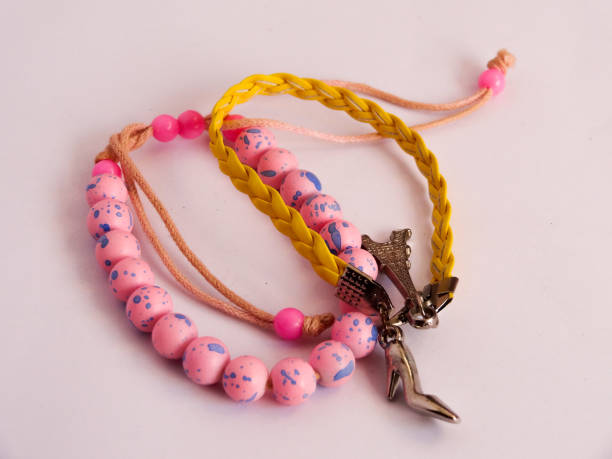 istock bracelet in pink and yellow on white background 1281483169