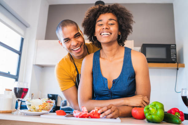 istock Latin couple cooking together in the kitchen. 1281484505