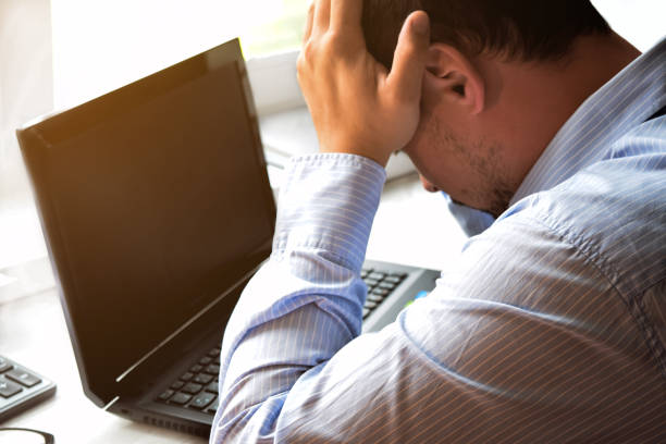 istock Businessman works in the office with laptop and documents on the table. Analyze plans, papers, keyboard hands. Blurred background, film effect. 1281486127