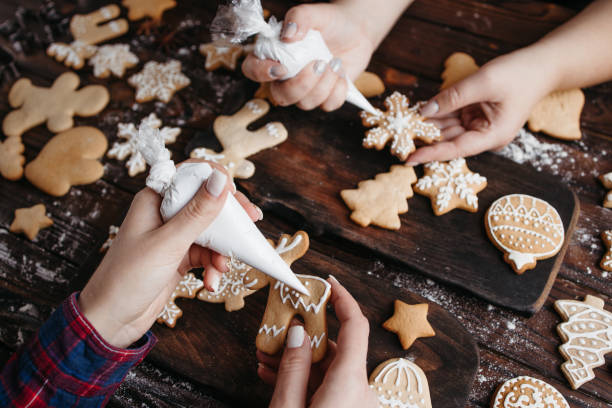 istock Friends decorating Christmas gingerbread cookies 1281487655