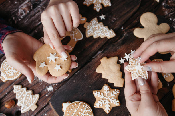 istock Friends decorating Christmas gingerbread cookies 1281487727