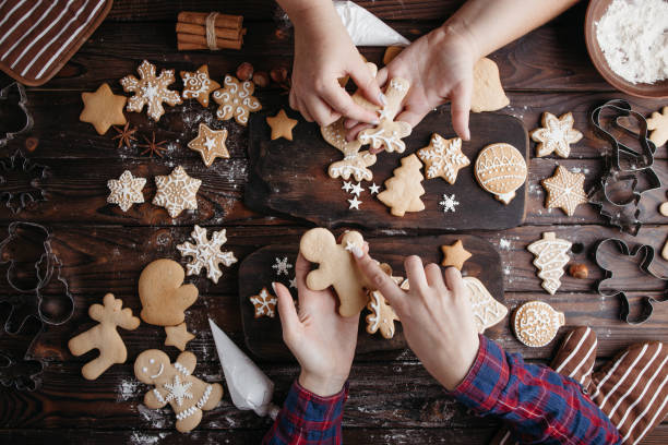 istock Friends decorating Christmas gingerbread cookies 1281487730