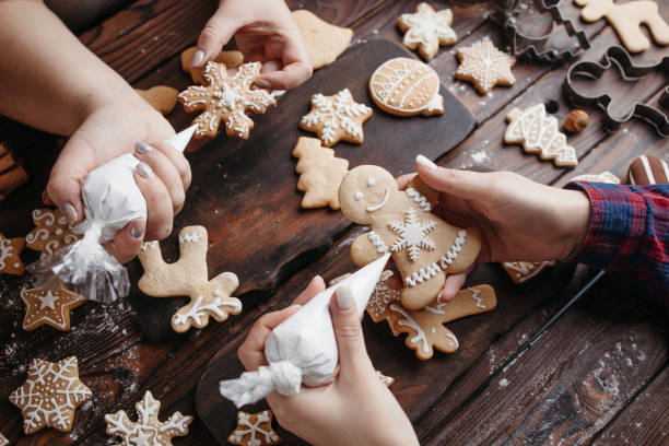 istock Friends decorating Christmas gingerbread cookies 1281487764