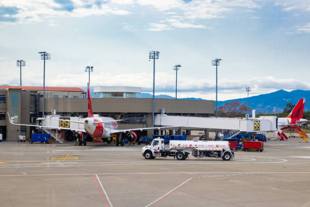 Fuel truck parking near airplane for fueling at the Alfonso Bonilla Aragon airport near Cali in Colombia Palmira, Colombia - October, 2020: Fuel truck parking near airplane for fueling at the Alfonso Bonilla Aragon airport near Cali in Colombia palmira colombia stock pictures, royalty-free photos & images