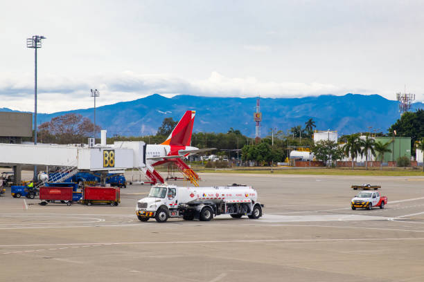 Fuel truck parking near airplane for fueling at the Alfonso Bonilla Aragon airport near Cali in Colombia Palmira, Colombia - October, 2020: Fuel truck parking near airplane for fueling at the Alfonso Bonilla Aragon airport near Cali in Colombia palmira colombia stock pictures, royalty-free photos & images