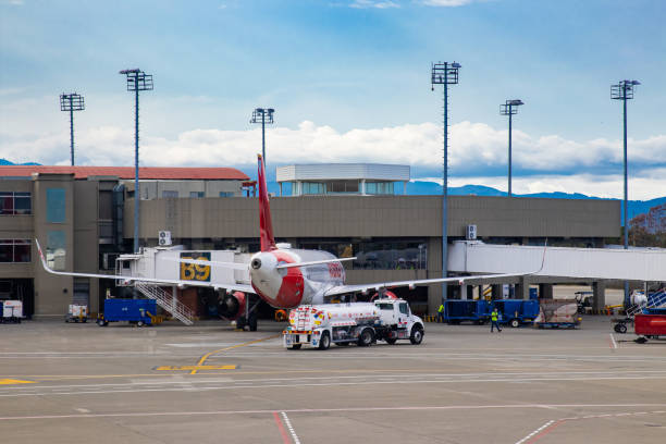 Fuel truck parking near airplane for fueling at the Alfonso Bonilla Aragon airport near Cali in Colombia Palmira, Colombia - October, 2020: Fuel truck parking near airplane for fueling at the Alfonso Bonilla Aragon airport near Cali in Colombia palmira colombia stock pictures, royalty-free photos & images