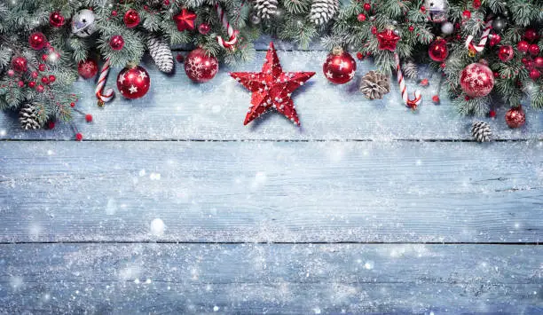 Photo of Fir Branches With Red Ornament On Snowy Plank - Christmas Background