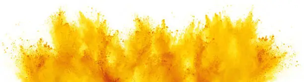 bright yellow holi paint color powder festival explosion isolated on white background. industrial print concept background