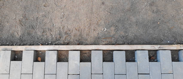 istock Building an pedestrian path with paver bricks. Sidewalk pavement 1281490017