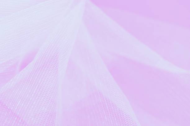 istock White small mesh fabric on pink background. Copy space, abstract blurred background 1281492222