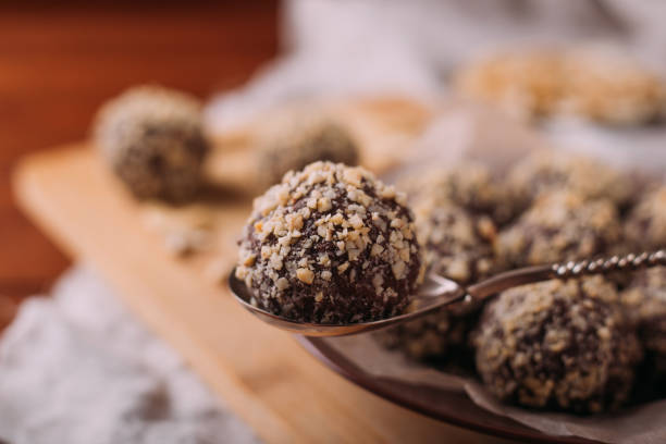 istock Cocoa balls, chocolate truffles cakes on board on wooden background 1281492477