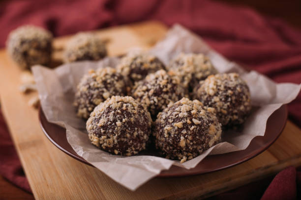 istock Cocoa balls, chocolate truffles cakes on board on wooden background 1281492484