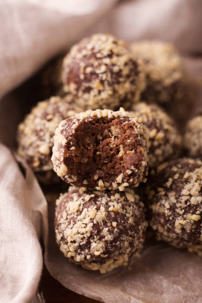 istock Cocoa balls, chocolate truffles cakes on board on wooden background 1281492518