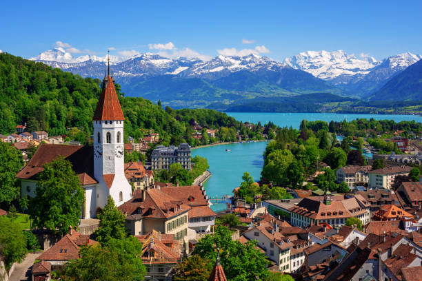 Thun city and lake in swiss Alps, Switzerland Historical Thun city and lake Thun with snow covered Bernese Highlands swiss Alps mountains in background, Canton Bern, Switzerland bern photos stock pictures, royalty-free photos & images