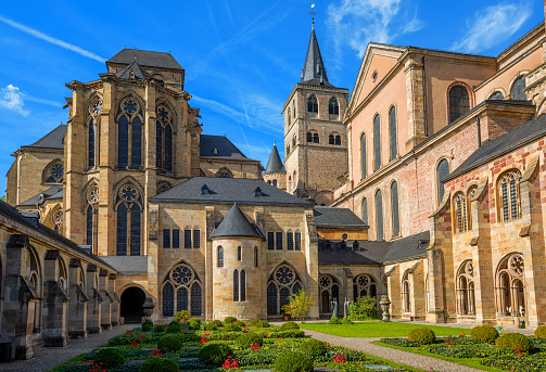 Historical romanesque and gothic style St Peter Cathedral in Trier, Germany, view from the cloister yard. The Cathedral is UNESCO world culture heritage site.