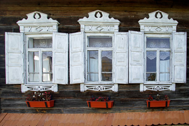 istock Windows in white frames in a chopped wooden house. 1281494034