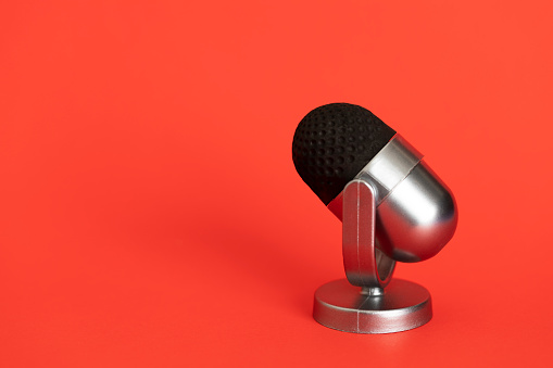 Microphone on red background.